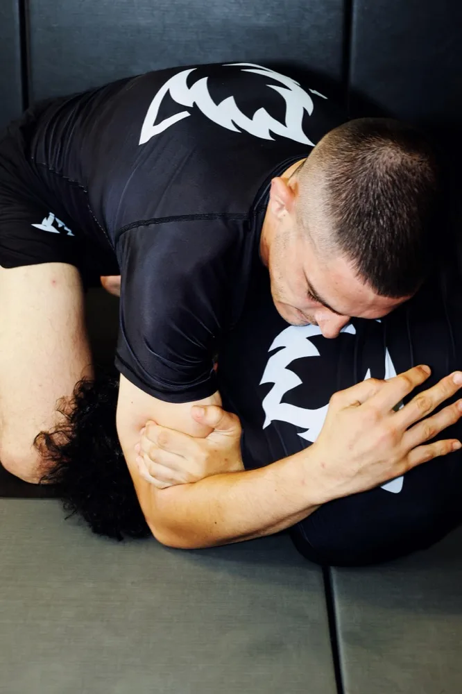 Grappler maintaining top control and pressure on an opponent during wrestling training at Lucid Jiu Jitsu